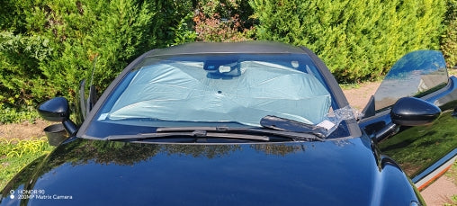 Parasole argentato installato su un’auto scura
